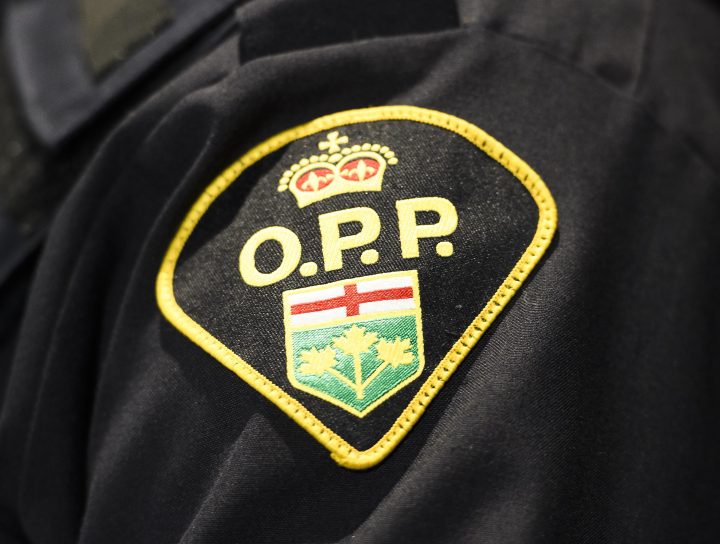 An Ontario Provincial Police logo is shown during a press conference.