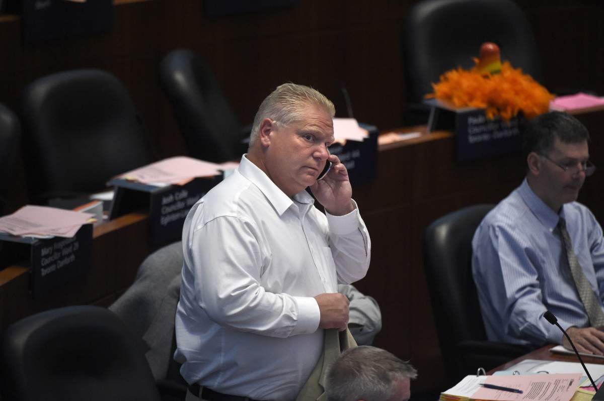 Toronto city councillor Doug Ford is photographed taking a phone call during council meeting at Toronto city hall on July 10 2014.