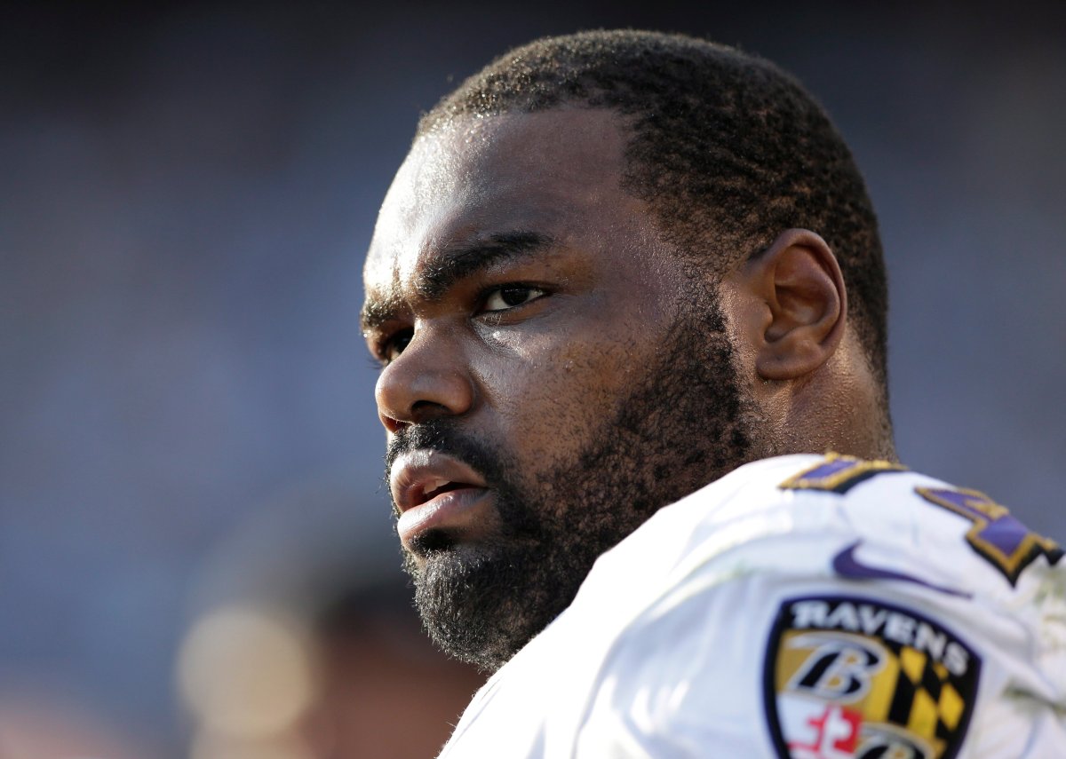 In this Nov. 25, 2012 photo, Baltimore Ravens tackle Michael Oher sits on the sidelines during the second half of an NFL football game against the San Diego Chargers, in San Diego.