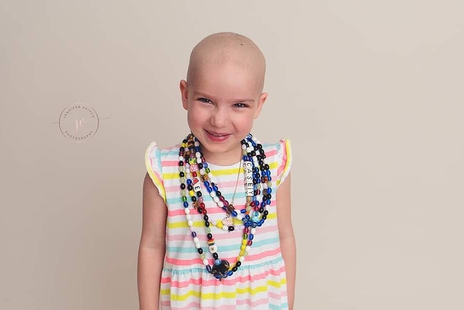 A photo of Casey in the middle of her treatment. Every bead represents a procedure. By the end she had double the number of beads in this photo.