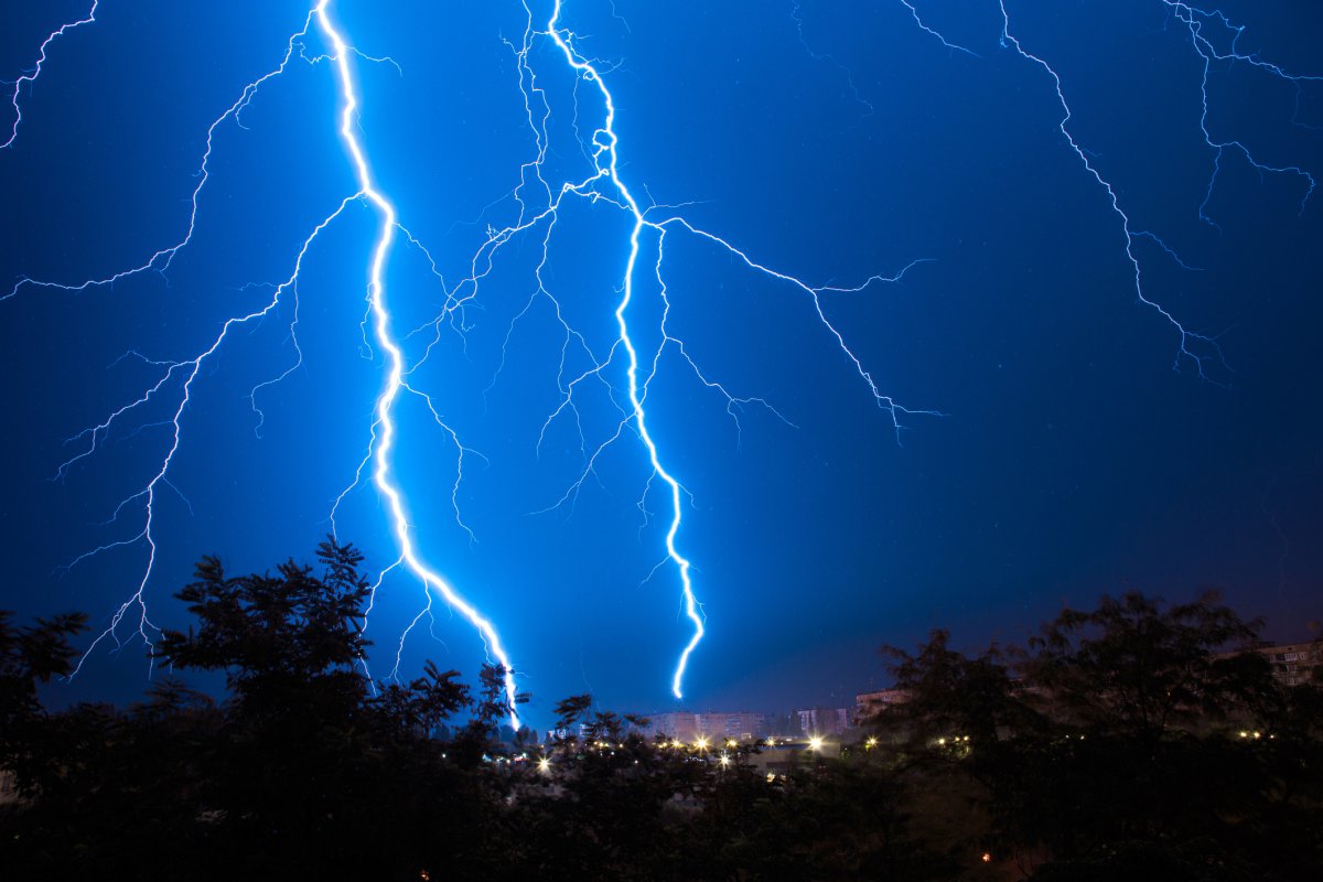 A stock image shows lightning strike a city.