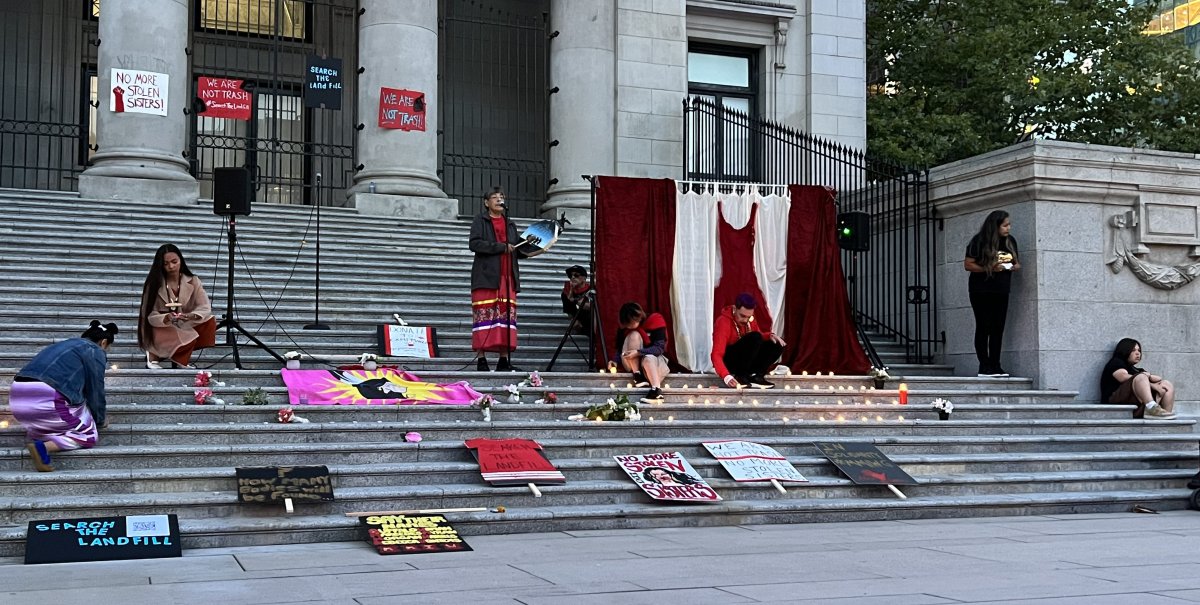 A candlelight vigil is set up on the steps of the Vancouver Art Gallery