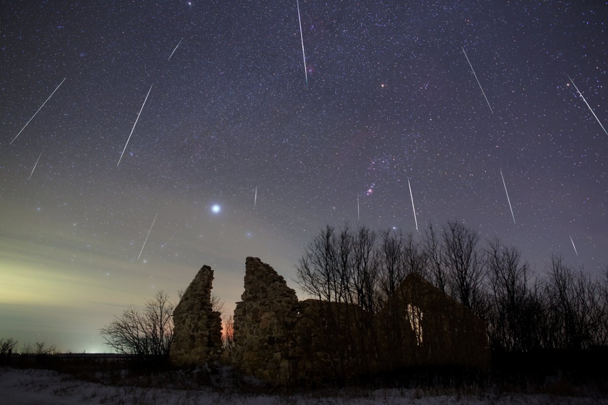 A meteor shower captured in Manitoba. Stars streaking across the night sky over a rock fixture.
