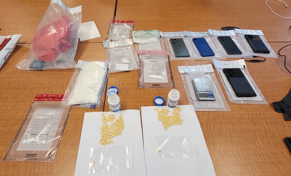 Cocaine, oxycodone and cellphones were seized during the arrest of a man wanted on warrants.
