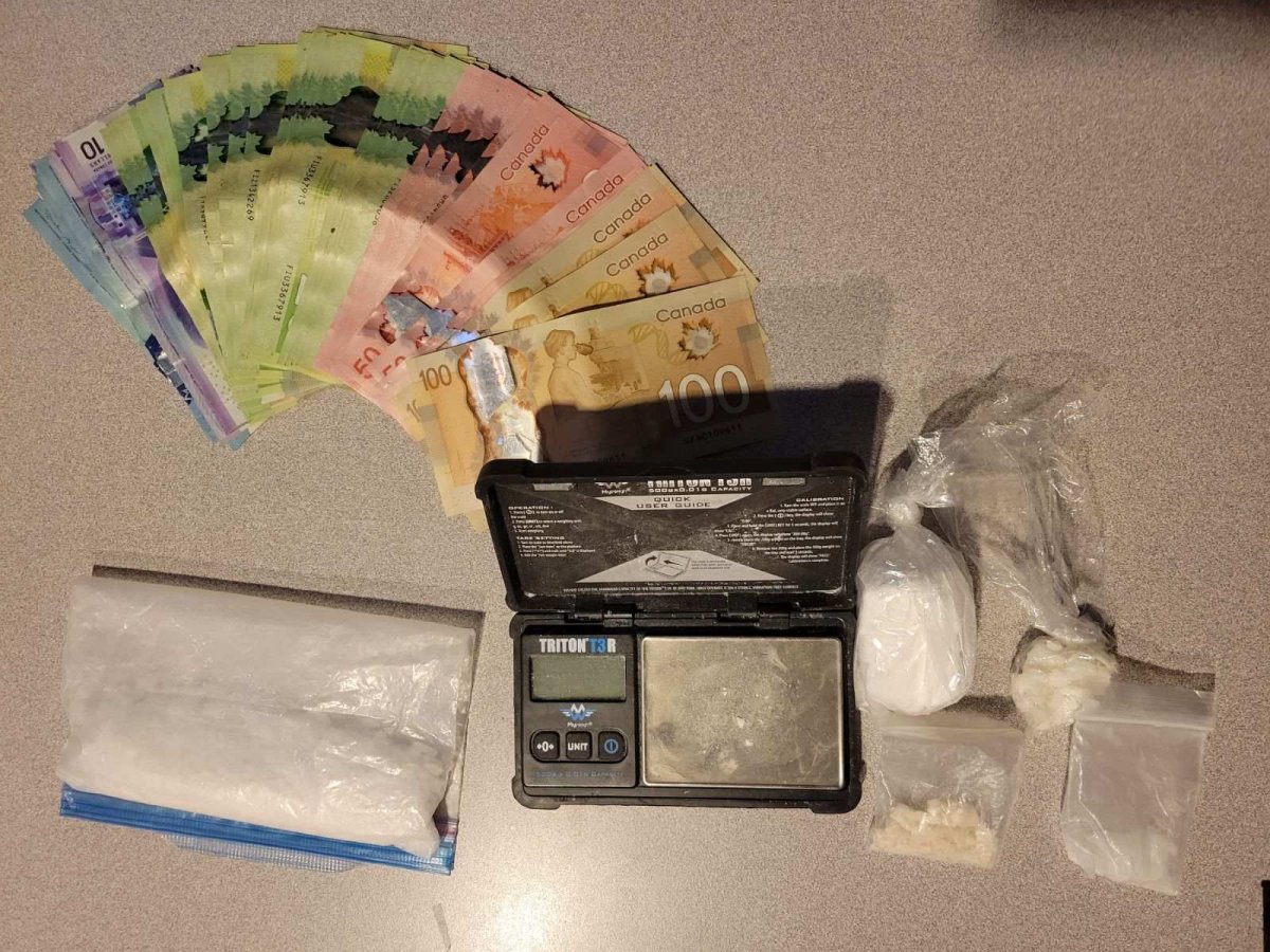 A police photo showing the drugs, paraphernalia and money seized during a traffic stop in Kelowna, B.C., on Aug. 1, 2023.