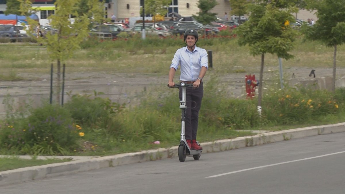 Laval mayor Stéphane Boyer rides an e-scooter. Tuesday August 1st, 2023.
