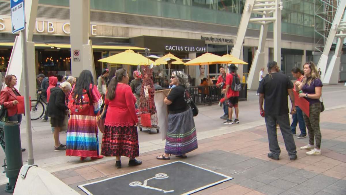 A crowd of Calgarians marched from Stephen Avenue to City Hallm wearing red clothing in support of Camp Morgan in Winnipeg, on Wednesday evening.