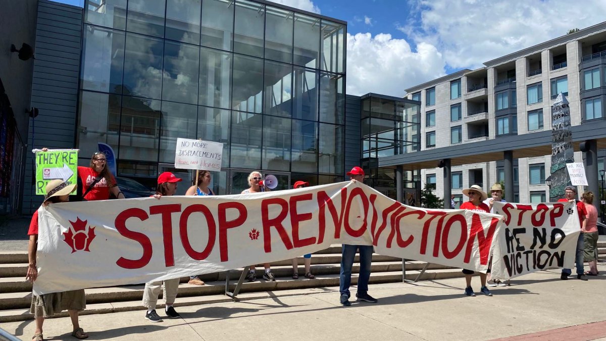 Members of a local tenants advocacy group rallying outside the Burlington Performing Arts Centre on August 1, 2023 where a local realtor was holding a speaking engagement.