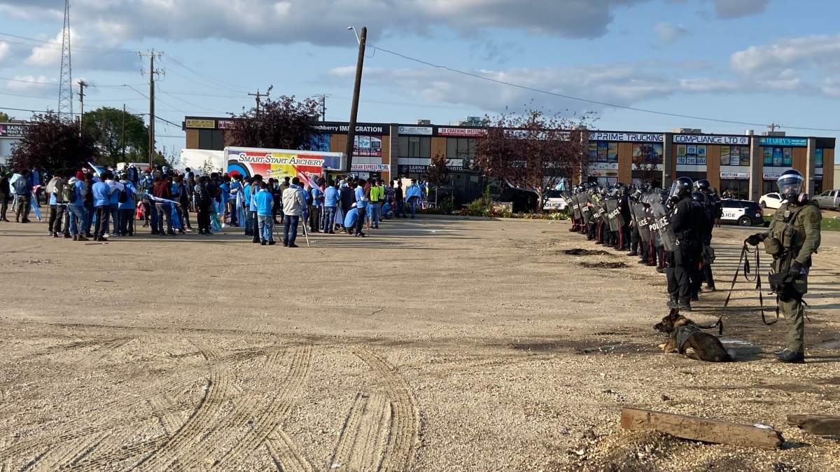 Edmonton Police Service members in riot tactical gear as anti-Eritrea protesters gather outside an Eritrean Festival event at the Maharaja Banquet Hall in southeast Edmonton on Saturday, August 19, 2023.