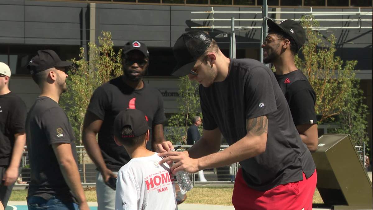 Centre Kylor Kelley signs the shirt of a Calgary Surge fan during the team’s season end celebration at Century Gardens on Aug. 15.