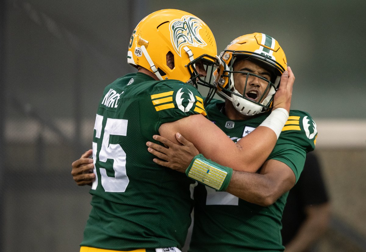 Elks quarterback Tre Ford and offensive lineman Mark Korte celebrate a touchdown in the first quarter against the Winnipeg Blue Bombers on Thursday, August 10, 2023.