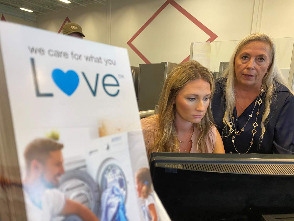 Bowest owner Patricia Warner and assistant Amanda Kadey look over emails.