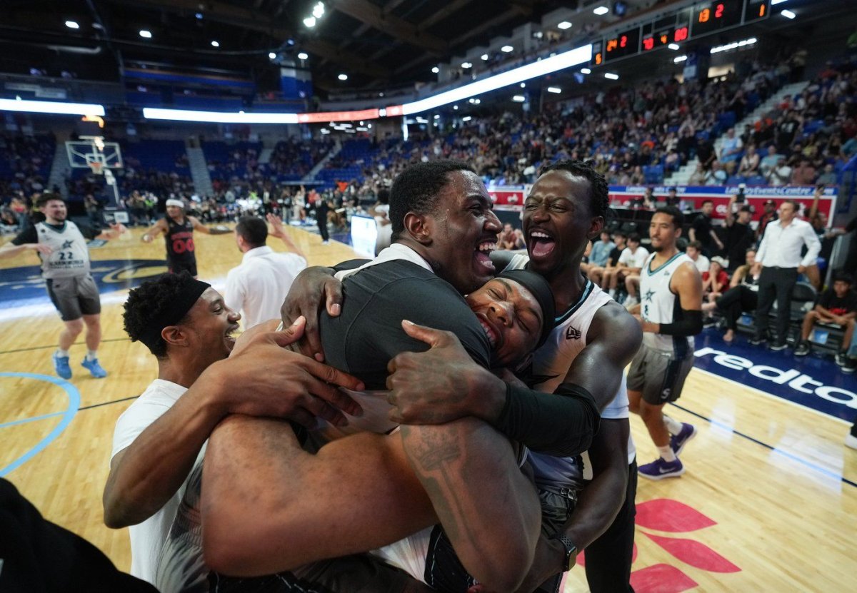 Scarborough Shooting Stars' Kalif Young, centre, Elijah Lufile, centre right, and Myck Kabongo, back right, celebrate after Scarborough defeated the Calgary Surge in the CEBL basketball championship final, in Langley, B.C., on Sunday, August 13, 2023. 