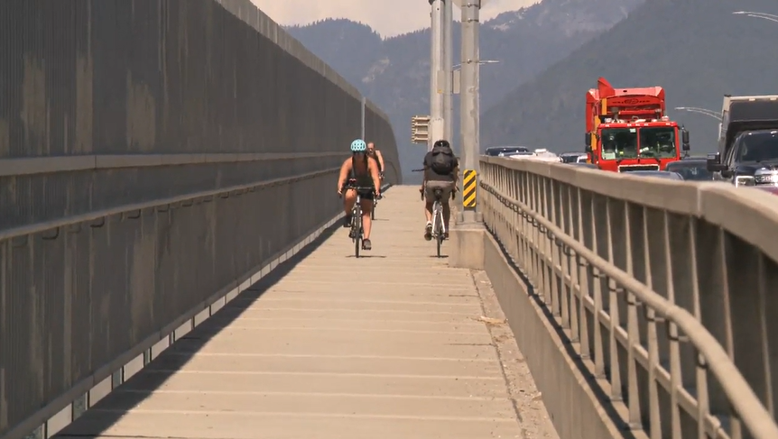 Cyclists split the west sidewalk of the Ironworkers Memorial Bridge connecting Vancouver to the North Shore on Tues. Aug. 1, 2023.