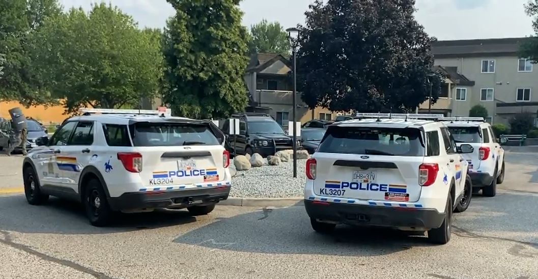 RCMP seen outside of a Kelowna condo complex on Monday, Aug. 7, 2023. 