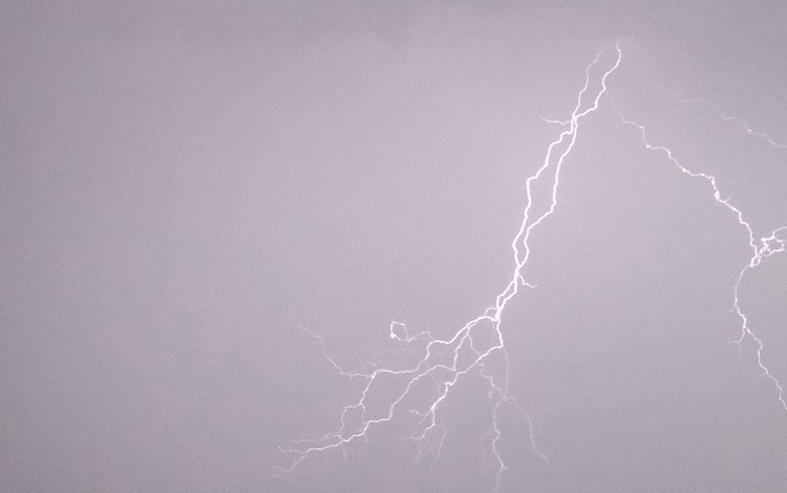 Lightning strikes in the sky during a severe thunderstorm warning.