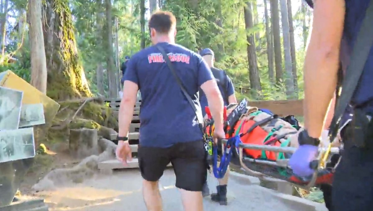 An injured swimmer is carried to safety from Lynn Canyon Tuesday, the second rescue in as many days in the popular North Vancouver park.  