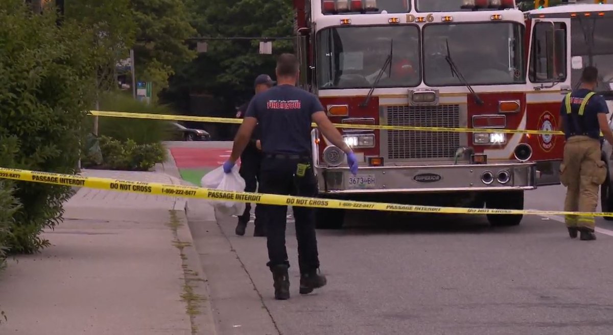 Firefighters at the scene of a fatal collision between a bus and a pedestrian in North Vancouver on Wednesday. 