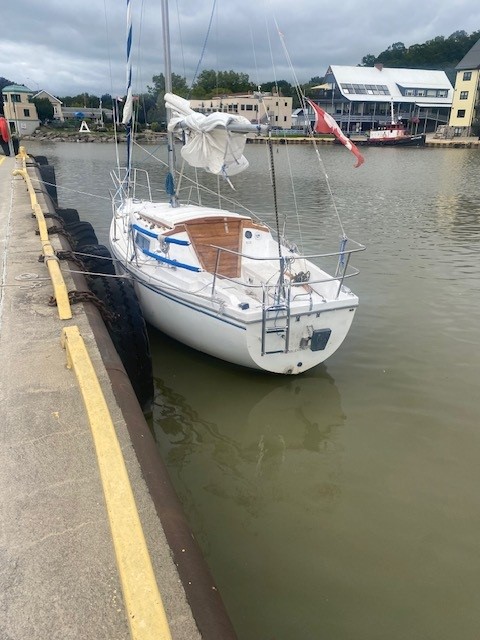 A photograph of a sailboat in a harbour.
