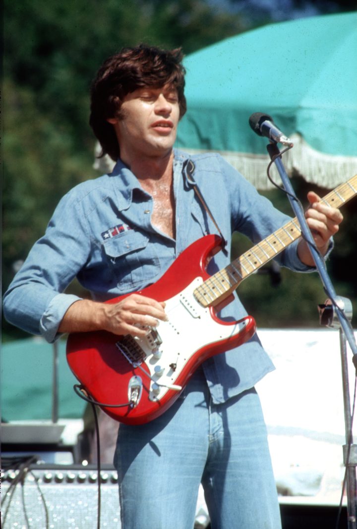 CALIFORNIA – JUNE 1976: Guitarist Robbie Robertson of the rock group ‘The Band’ plays his Fender Stratocaster electric guitar as he performs outside onstage in June 1976.