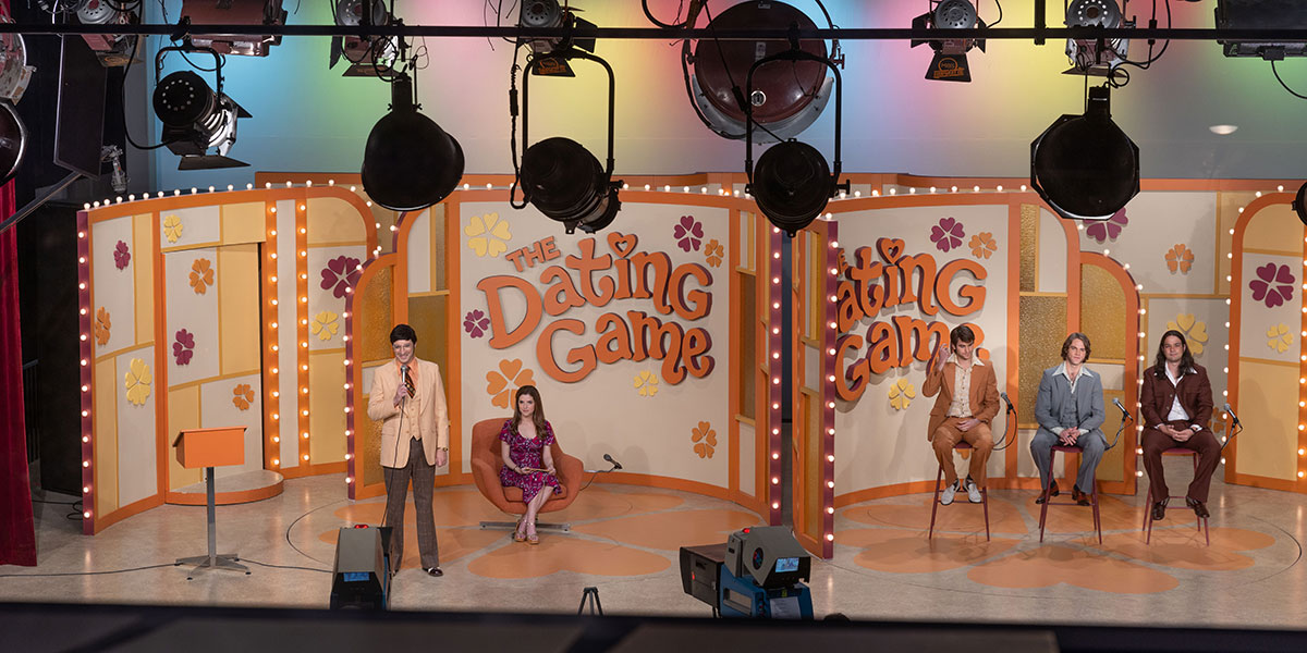 A still from 'Woman of the Hour.' It is a orange game show set.