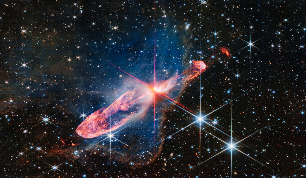 The James Webb Space Telescope has captured a tightly bound pair of actively forming stars, shown here as the orange-white splotch in the middle of the red diffraction spikes, at image centre.