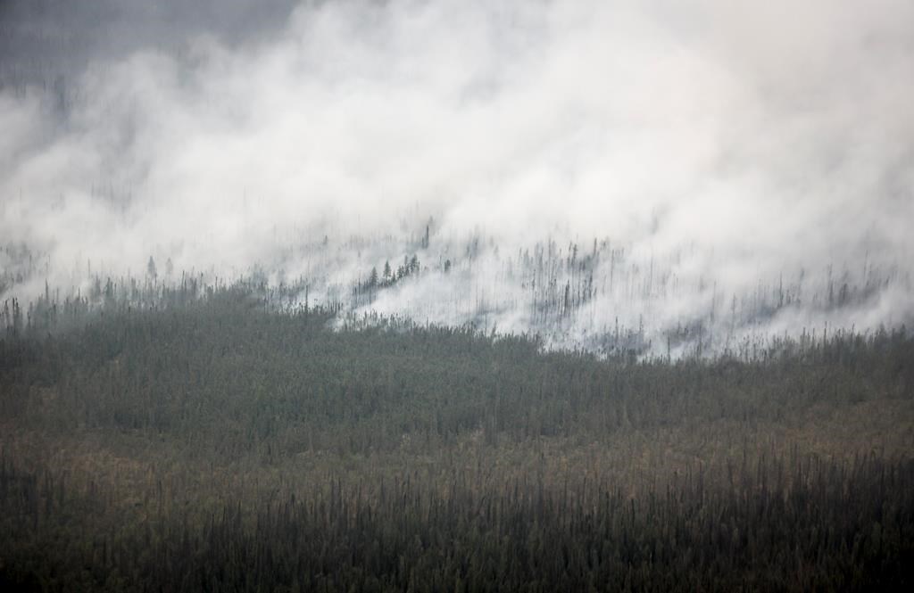 A wildfire burns south of Enterprise, N.W.T., Thursday, Aug. 17, 2023.