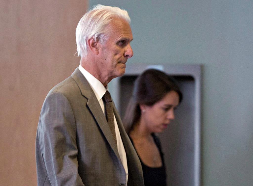 Quebec's Court of Appeal has overturned a stay of proceedings granted to retired Quebec judge Jacques Delisle, whose conviction for fatally shooting his wife in 2012 was reversed by the federal justice minister. Delisle, left, walks into court with his granddaughter Anne Sophie Morency, Thursday, June 14, 2012 in Quebec City. THE CANADIAN PRESS/Jacques Boissinot.