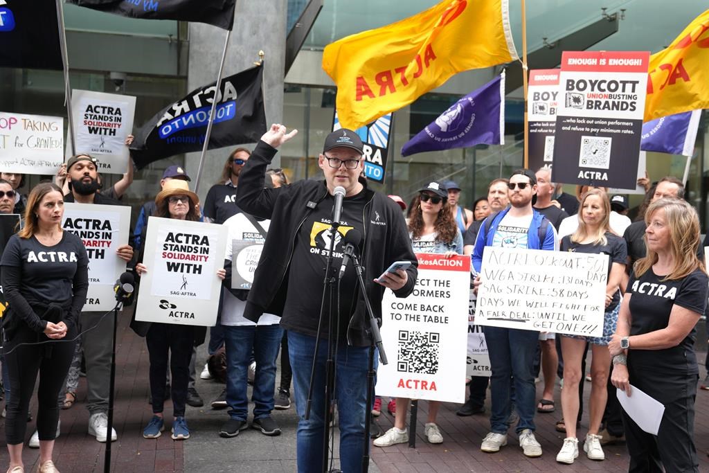 Duncan Crabtree-Ireland, the Screen Actors Guild - American Federation of Television and Radio Artists (SAG-AFTRA) chief negotiator, speaks as he is joined by members of the Alliance of Canadian Cinema Television Radio Artists (ACTRA). The unions held a joint rally outside the Canadian headquarters of Amazon and Apple in Toronto, Saturday, Sept. 9, 2023. 
