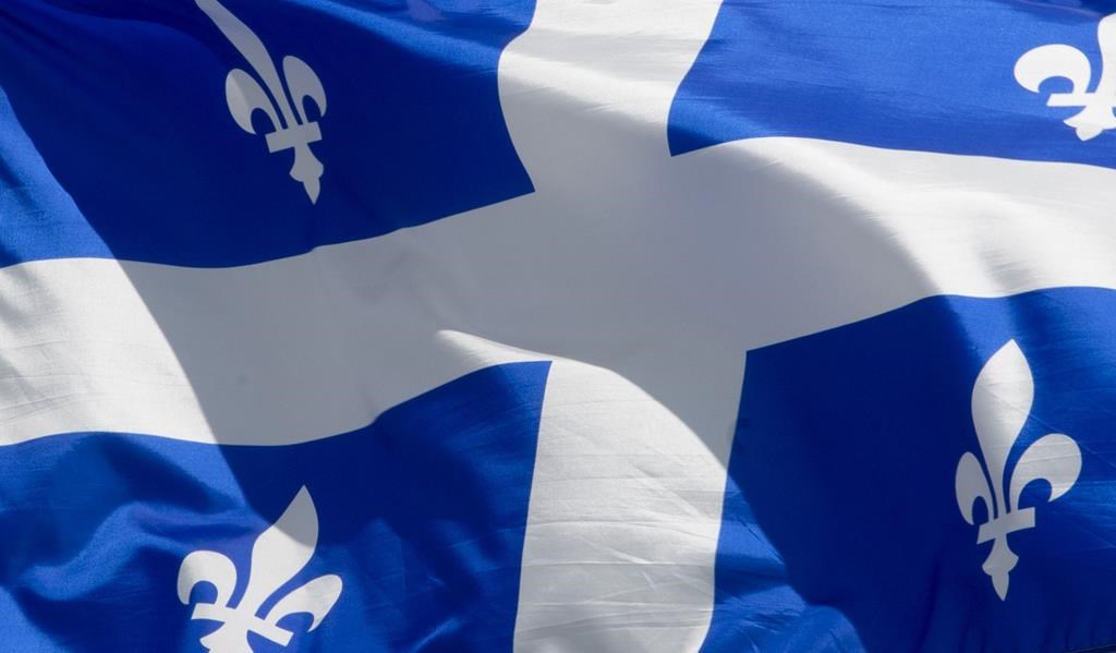 A settlement has been reached in a class-action lawsuit against the Frères de Saint-Gabriel religious order. Quebec's provincial flag flies in Ottawa on June 30, 2020. 