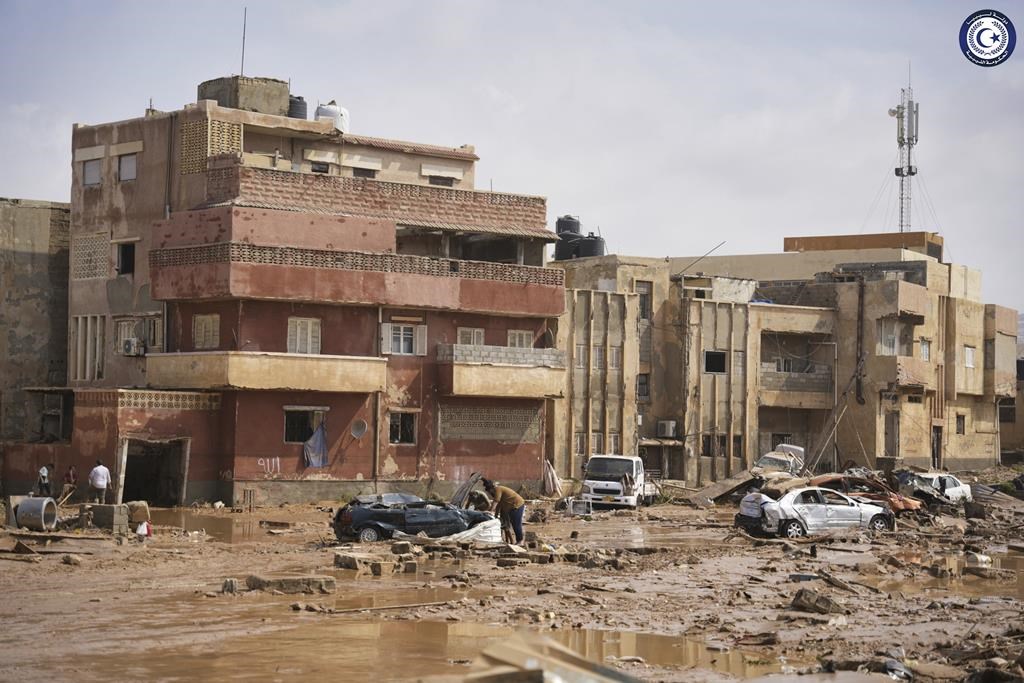 In this photo provided by the Libyan government, cars and rubble sit in a street in Derna, Libya, on Monday, Sept. 11, 2023, after it was flooded by heavy rains. Mediterranean storm Daniel caused devastating floods in Libya that broke dams swept away entire neighborhoods and wrecked homes in multiple coastal towns in the east of the North African nation. As many as 2,000 people were feared dead one of the country’s leaders said.