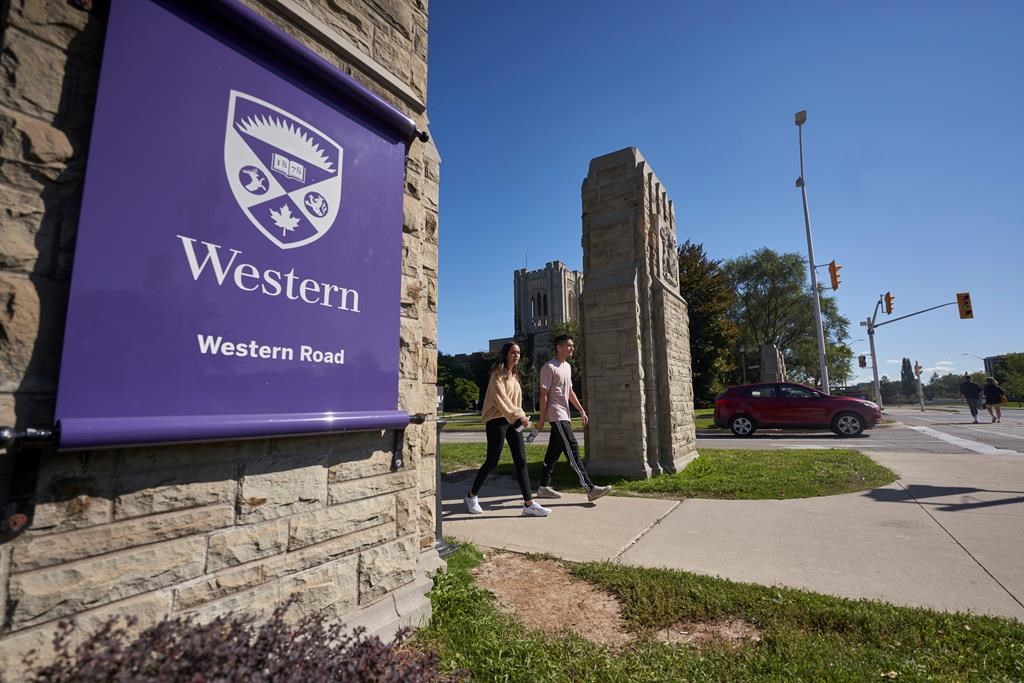Students walk across campus at Western University in London, Ont., Saturday, Sept. 19, 2020. THE CANADIAN PRESS/Geoff Robins.
