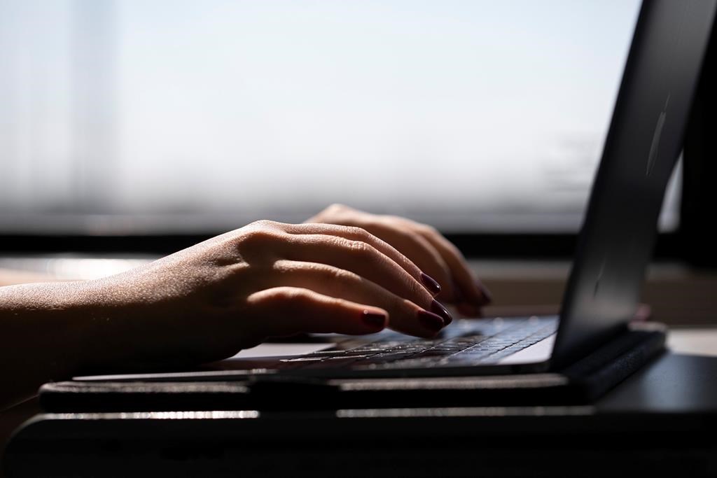 A woman types on a laptop in this file photo. 