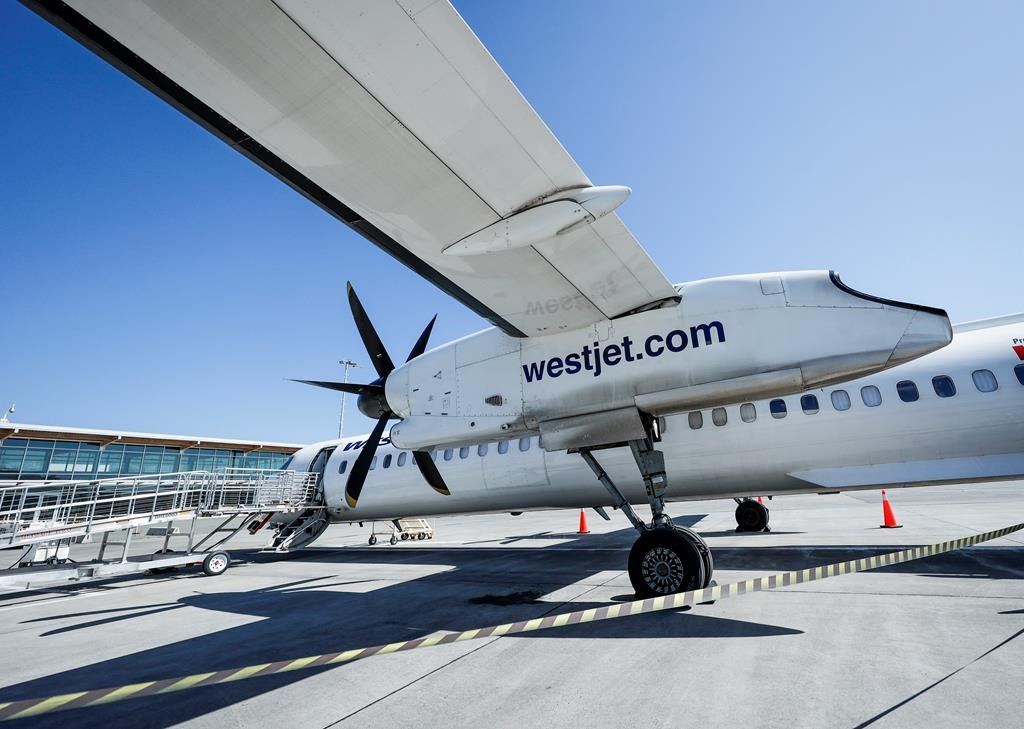 The CEO of Canada's second-largest airline says the global push to decarbonize the aviation sector by 2050 will lead to a major increase in ticket prices unless governments step in to offer support. A WestJet Encore Bombardier Q400 twin-engined turboprop aircraft is prepared for a flight in Kamloops, Saturday, June 3, 2023.