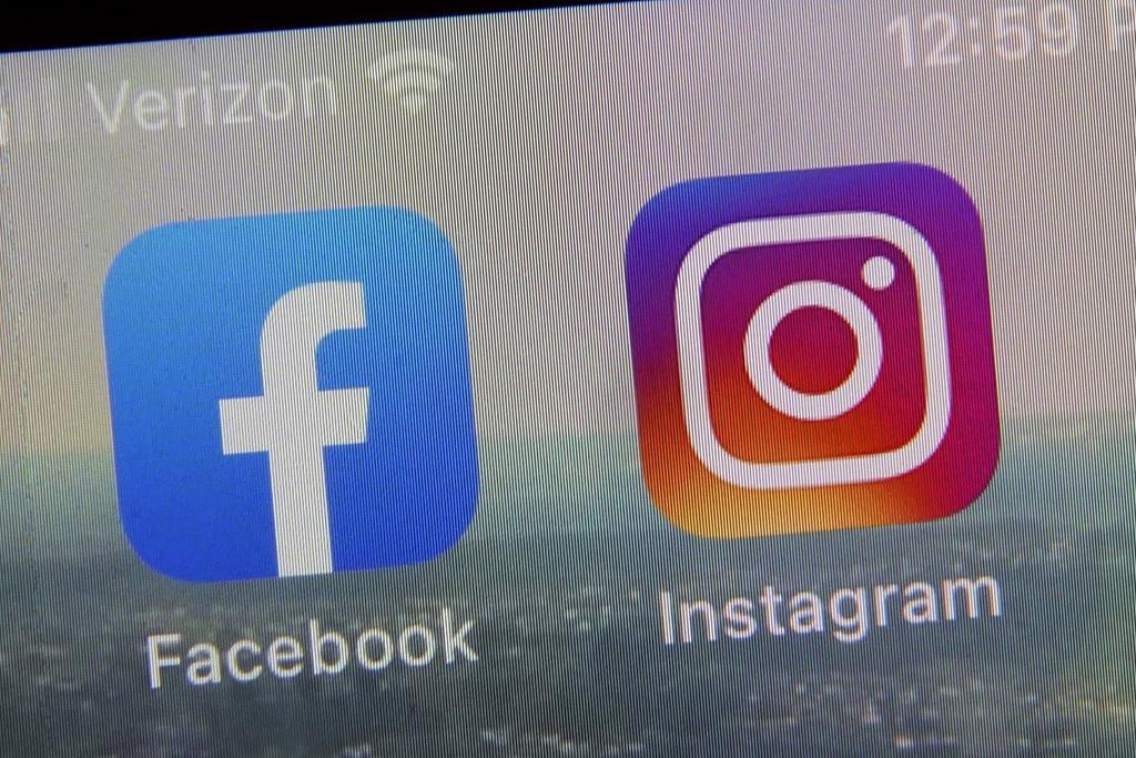This file photo shows the mobile phone app logos for, from left, Facebook and Instagram.