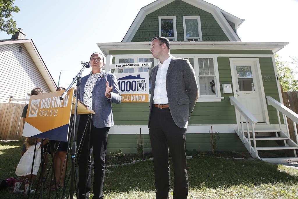 Manitoba New Democrats are promising financial help for families who want to make the switch to a geothermal heating and cooling system if elected on Oct. 3. Wab Kinew, leader of the Manitoba NDP, left, speaks during a press conference in Winnipeg Friday, Aug. 16, 2019, as Adrien Sala, NDP candidate for St James, listens in. 