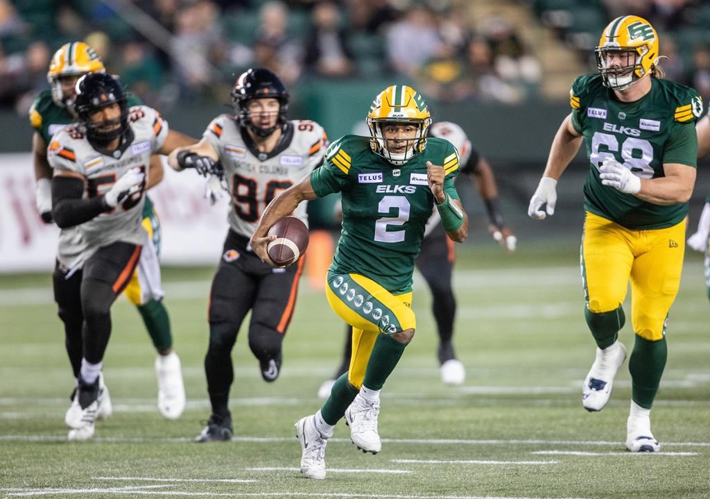 Edmonton Elks quarterback Tre Ford (2) runs the ball as B.C. Lions' Mathieu Betts (90) and Woody Baron (58) chase during first half CFL action in Edmonton on Friday, September 22, 2023. He’s moved his team into playoff contention — albeit barely — Tre Ford has provided the Edmonton Elks and their beleaguered fans with something much more tangible: hope for the future.