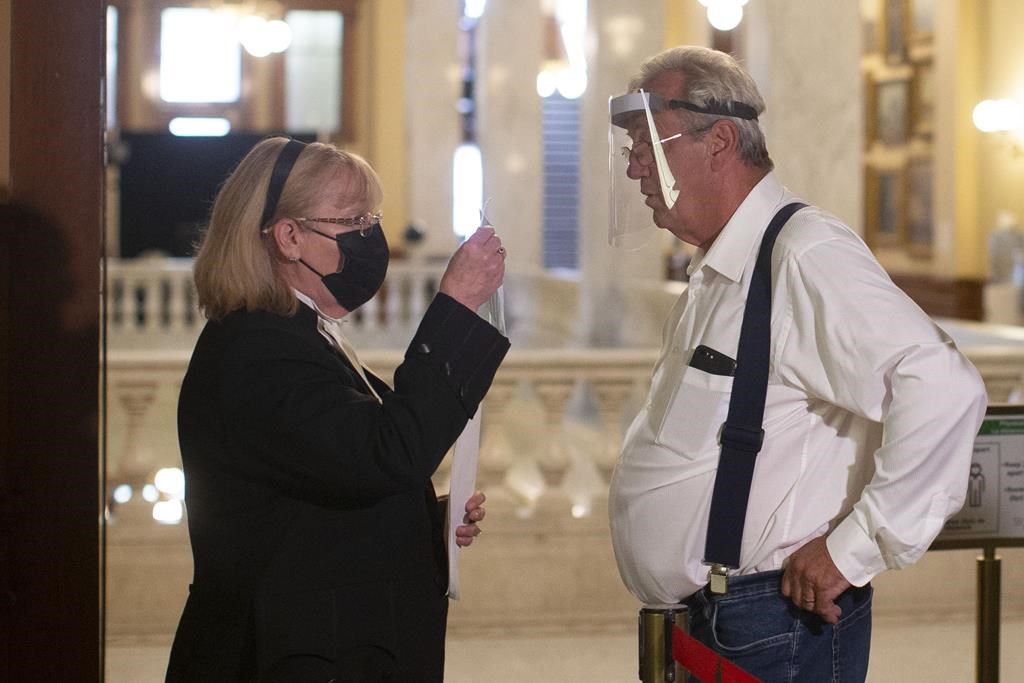 Independent MPP Randy Hiller, right, speaks to a clerk as he is refused entry for not wearing a mask at the Queen's Park Legislature in Toronto on Monday, June 14, 2021. Hillier, who is facing charges related to his participation in the 'Freedom Convoy' protests, has had his request to move his jury trial away from Ottawa denied.