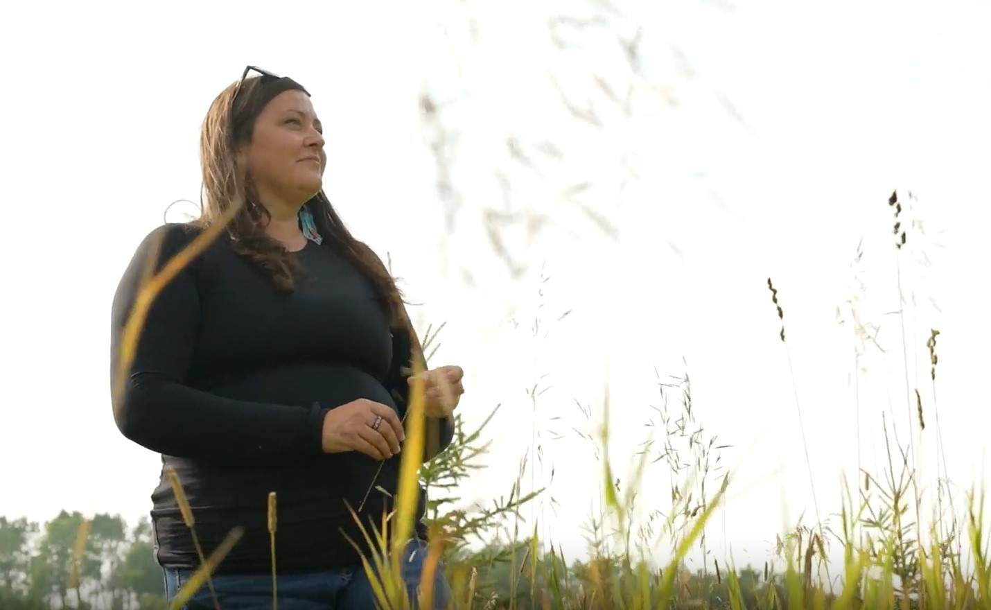 Amy Cardinal Christianson, a research scientist with the Canadian Forest Services, makes note of areas on her property to conduct a cultural burn.
