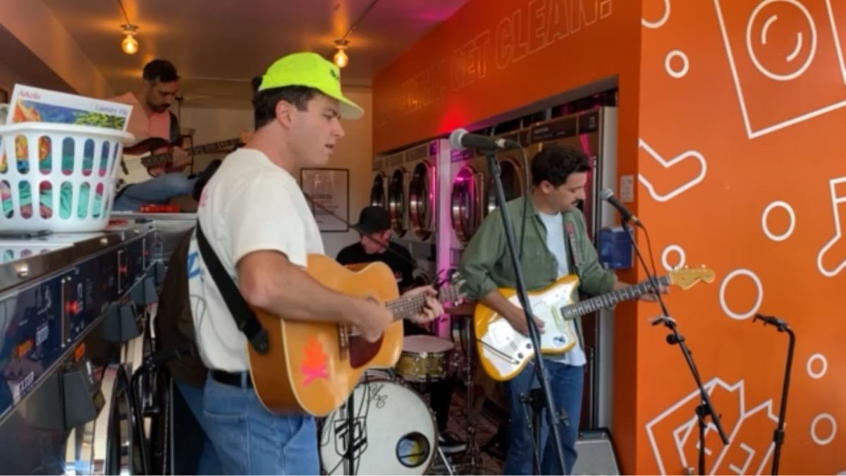 Photo of Arkells and frontman Max Kerman performing at Splash Laundry on Main Street East In Hamilton.