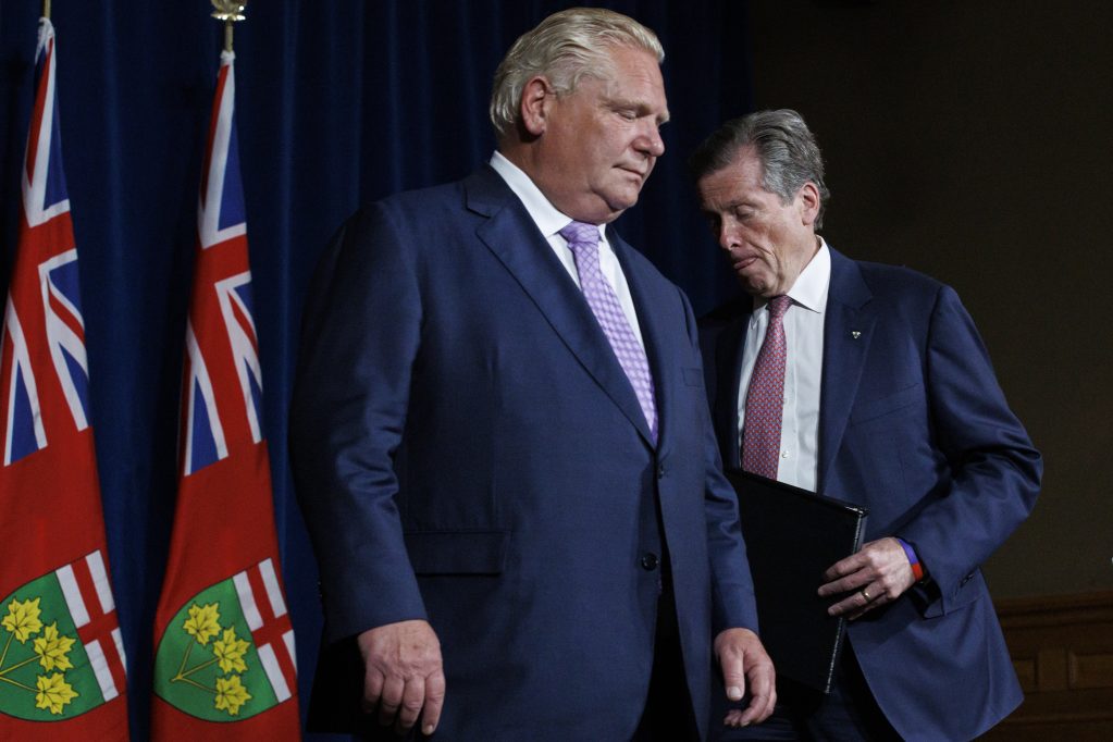 Ontario Premier Doug Ford and Toronto Mayor John Tory, shuffle during a joint press conference inside Queen’s Park in Toronto, Monday, June 27, 2022. THE CANADIAN PRESS/Cole Burston