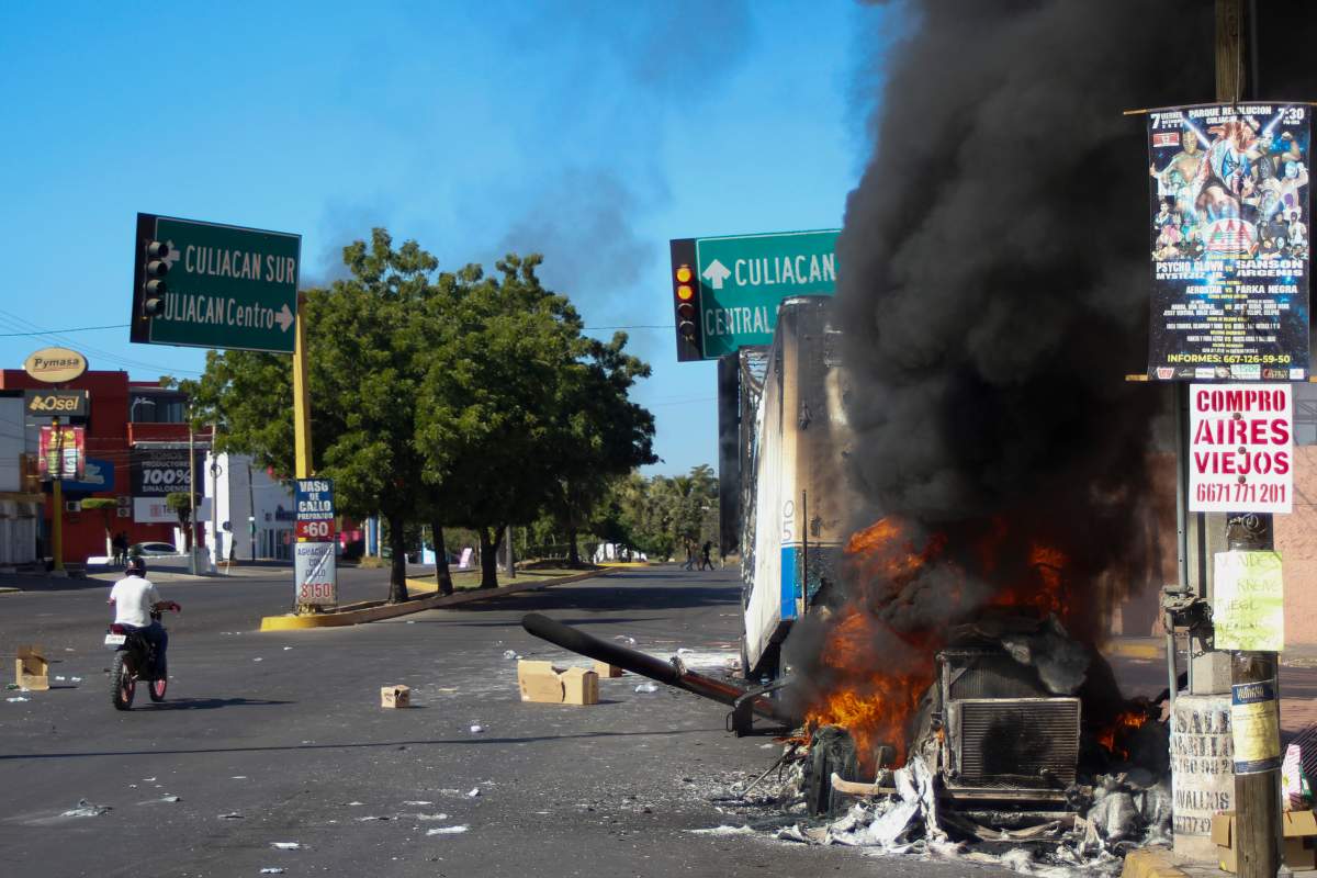 FILE – A truck burns after being set on fire in Culiacan, Sinaloa state, Mexico, Jan. 5, 2023, the day the government detained Ovidio Guzman, the son of imprisoned drug lord Joaquin “El Chapo” Guzman, which unleashed deadly firefights between the military and suspected members of the Sinaloa drug cartel. With Sinaloa cartel boss Joaquín “El Chapo” Guzmán serving a life sentence, his sons steered the family business into fentanyl, establishing a network of labs churning out massive quantities they smuggled into the U.S., prosecutors in the U.S. revealed in an indictment unsealed April 14, 2023 in Manhattan. (AP Photo/Martin Urista, File)
