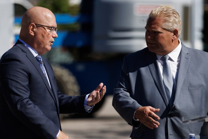 Ontario Premier Doug Ford, right, welcomes Ontario’s minister of housing Steve Clark to the podium during a press conference in Mississauga, Ont., Friday, Aug. 11, 2023. THE CANADIAN PRESS/Cole Burston