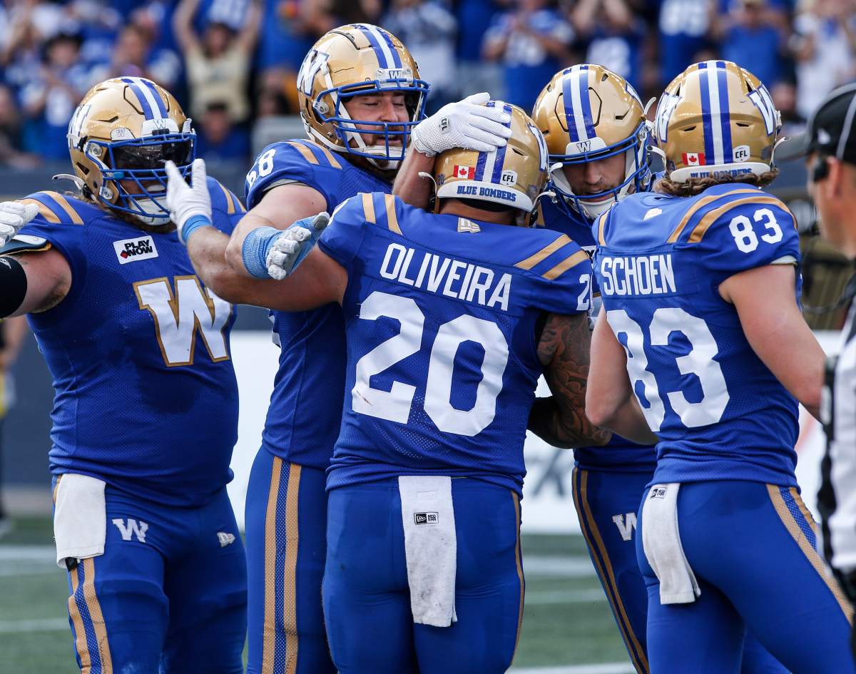 Winnipeg Blue Bombers players celebrate Brady Oliveira’s (20) touchdown against the Saskatchewan Roughriders during the first half of CFL football action in Winnipeg Saturday, September 9, 2023.