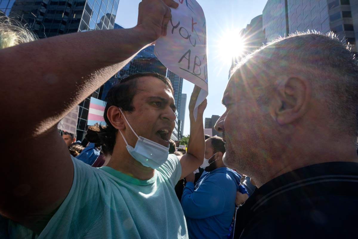 A pro-trans rights counter demonstrator, left, exchanges views with a demonstrator against sexual orientation and gender identity programs in schools, in Montreal, Wednesday, Sept. 20, 2023.