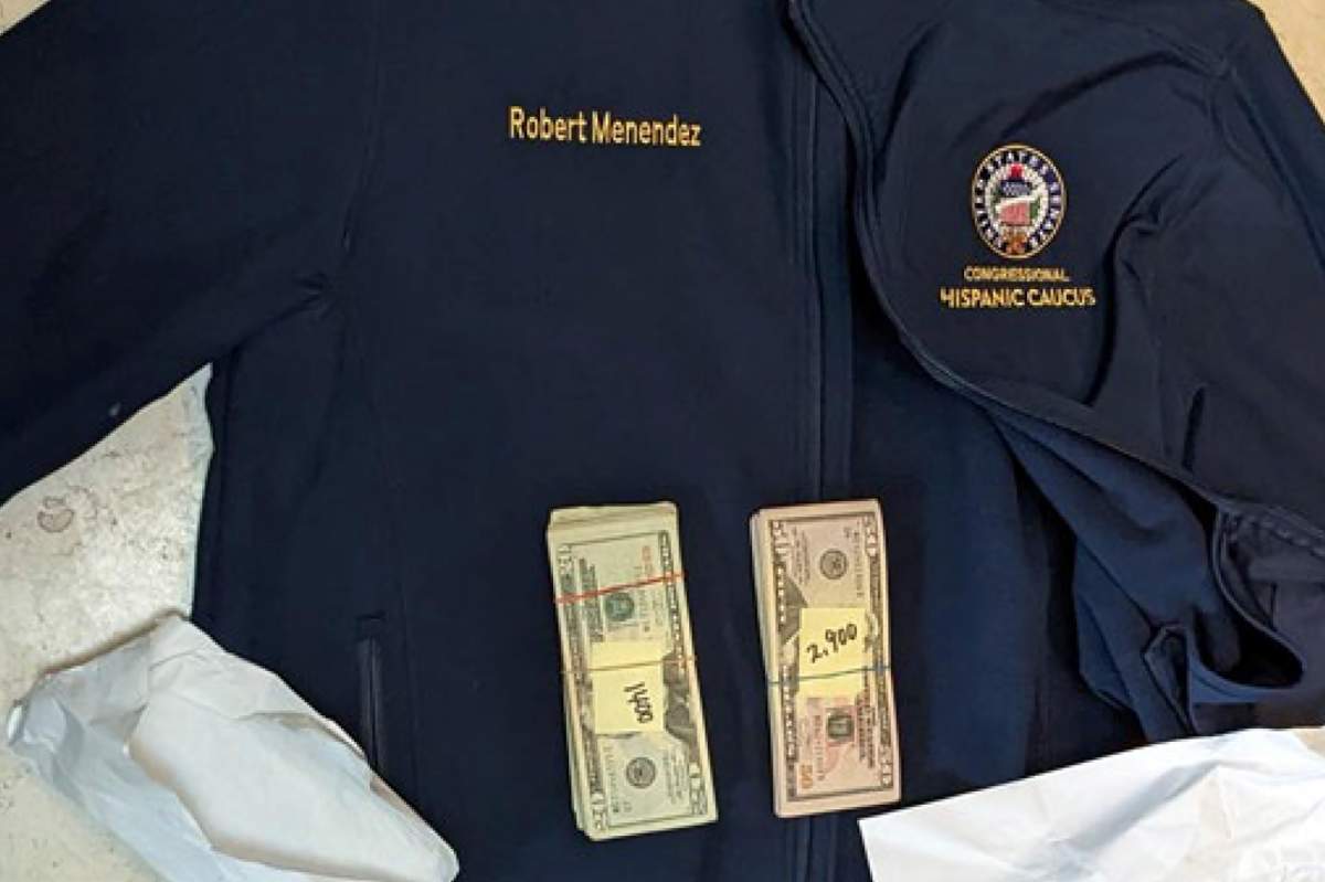 This photo, which was included in an indictment of U.S. Sen. Bob Menendez (D-N.J.), shows a jacket bearing Menendez’s name, along with cash from envelops found inside the Jacket during a search by federal agents of the senator’s home in Harrison, N.J., in 2022. Federal prosecutors announced charges of bribery against Menendez and his wife, Nadine Arslanian Menendez, on Friday, Sept. 22, 2023. (U.S. Attorney’s Office via AP)
