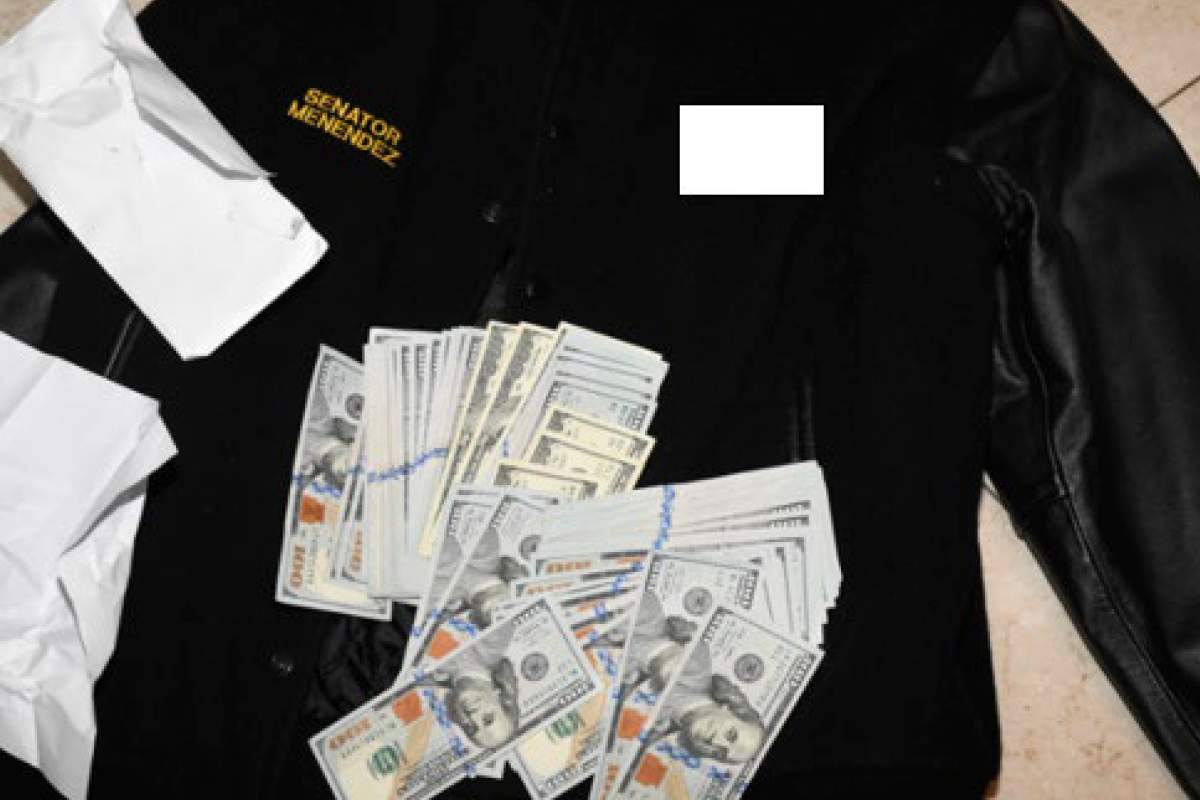 This photo, which was included in an indictment of U.S. Sen. Bob Menendez (D-N.J.), shows a jacket bearing Menendez’s name, along with cash from envelops found inside the Jacket during a search by federal agents of the senator’s home in Harrison, N.J., in 2022. Federal prosecutors announced charges of bribery against Menendez and his wife, Nadine Arslanian Menendez, on Friday, Sept. 22, 2023. Additional information on the jacket was redacted by the source. (U.S. Attorney’s Office via AP)