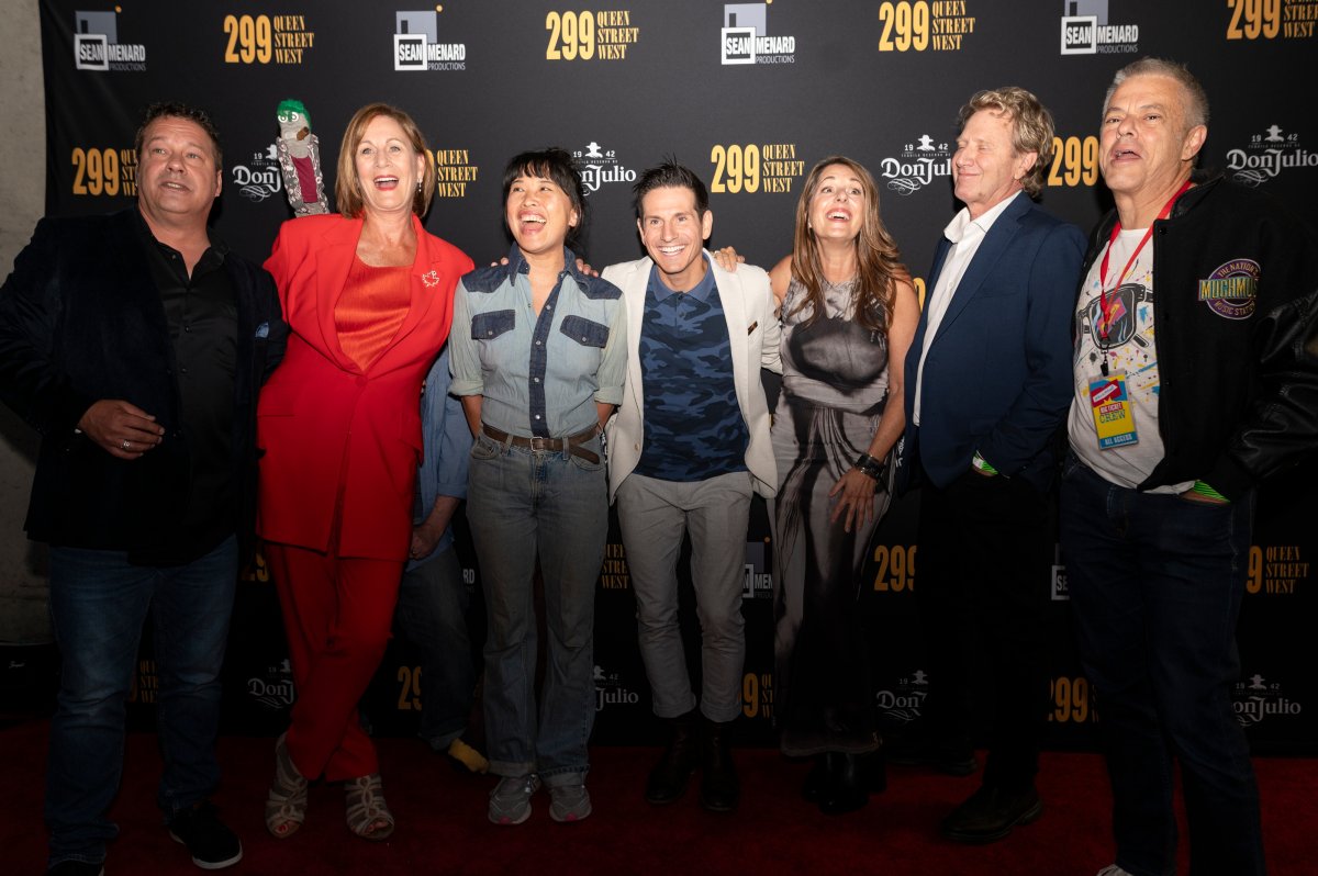 People posing for a photo at a documentary premiere.