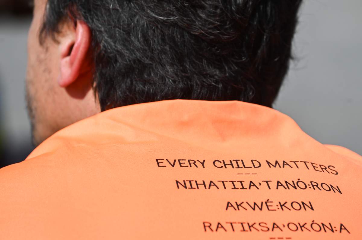 A man wears a tee-shirt with the words Every Child Matters printed in different languages during a march on National Day for Truth and Reconciliation in Montreal, Saturday, September 30, 2023.