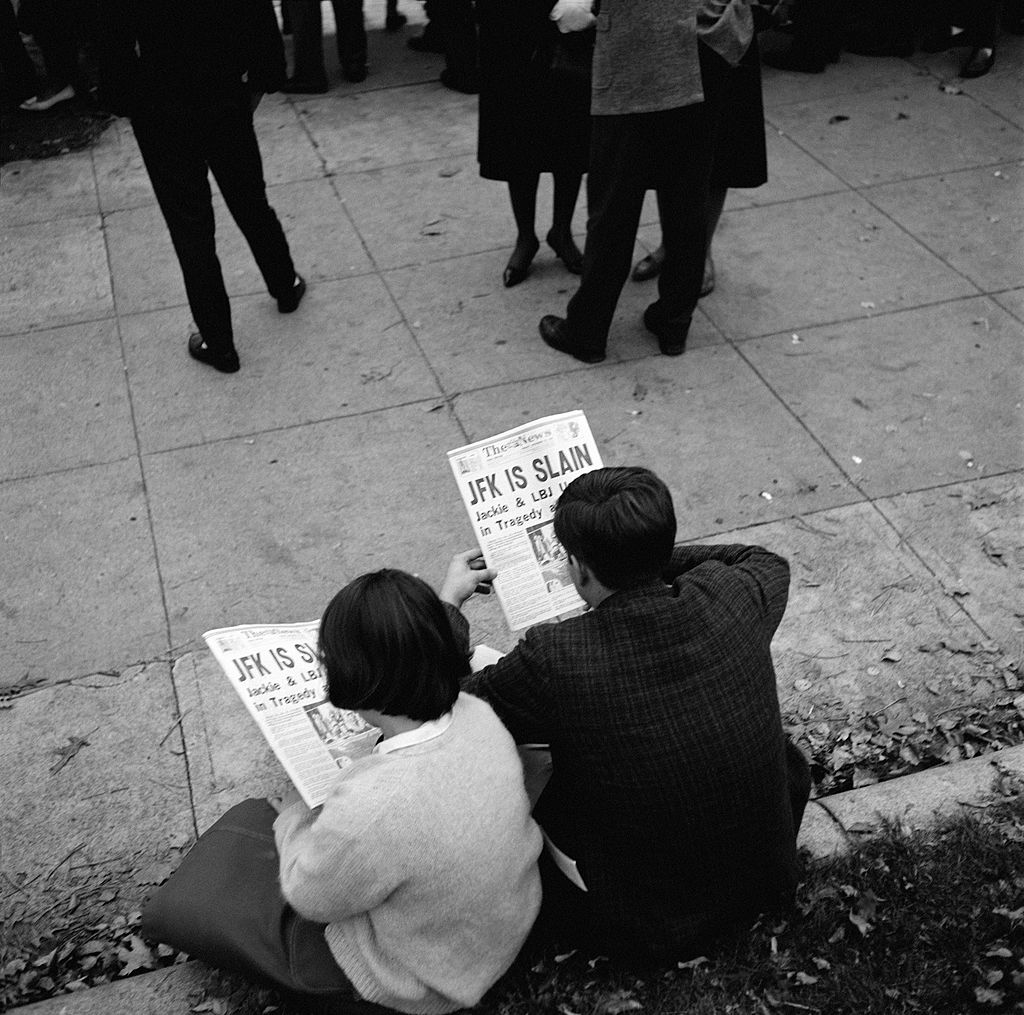 People reading newspapers in Lafayette Park after the assassination of President John Fitzgerald Kennedy on November 23, 1963 in Washington D.C.